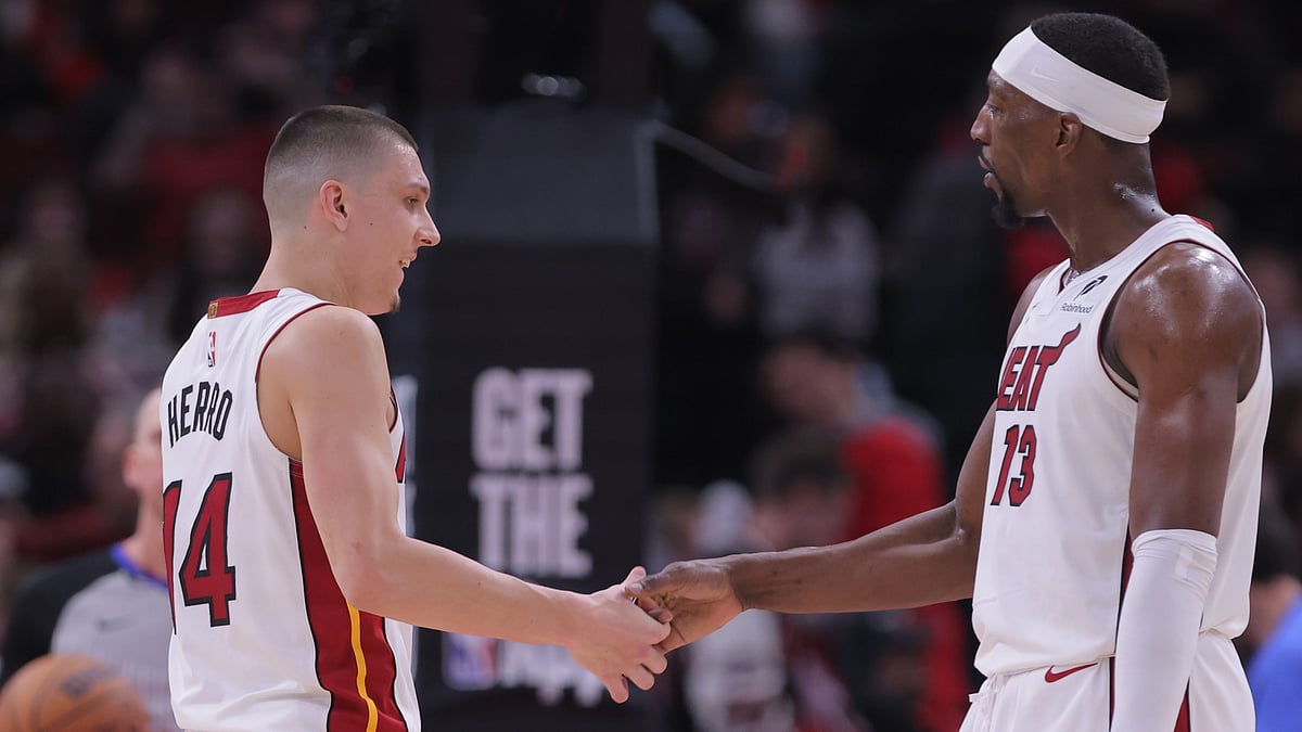 Tyler Herro #14 of the Miami Heat and Bam Adebayo #13 of the Miami Heat celebrate during the second half of the 2025 SoFi Play-In Tournament against the Chicago Bulls on April 16, 2025 at the United Center in Chicago, Illinois.