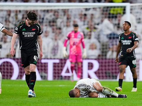 Arsenal's Declan Rice looks at Real Madrid's Kylian Mbappe (on the ground) during their UEFA Champions League quarter-final second-leg match at the Santiago Bernabeu Stadium in Madrid, Spain on April 16, 2025.