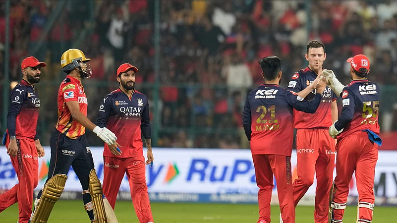 Royal Challengers Bengalurus Josh Hazlewood, second right, celebrates. AP