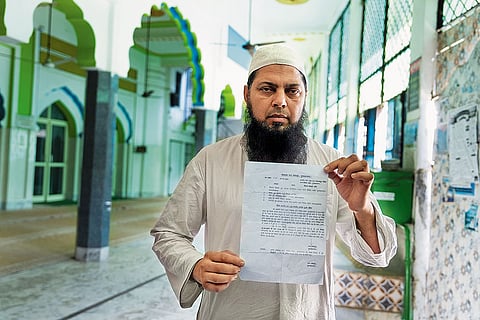 Silent Protest: Mujeeb Shibli, the caretaker of Ayesha Mosque in Muzaffarnagar, shows the notice that was issued to him
