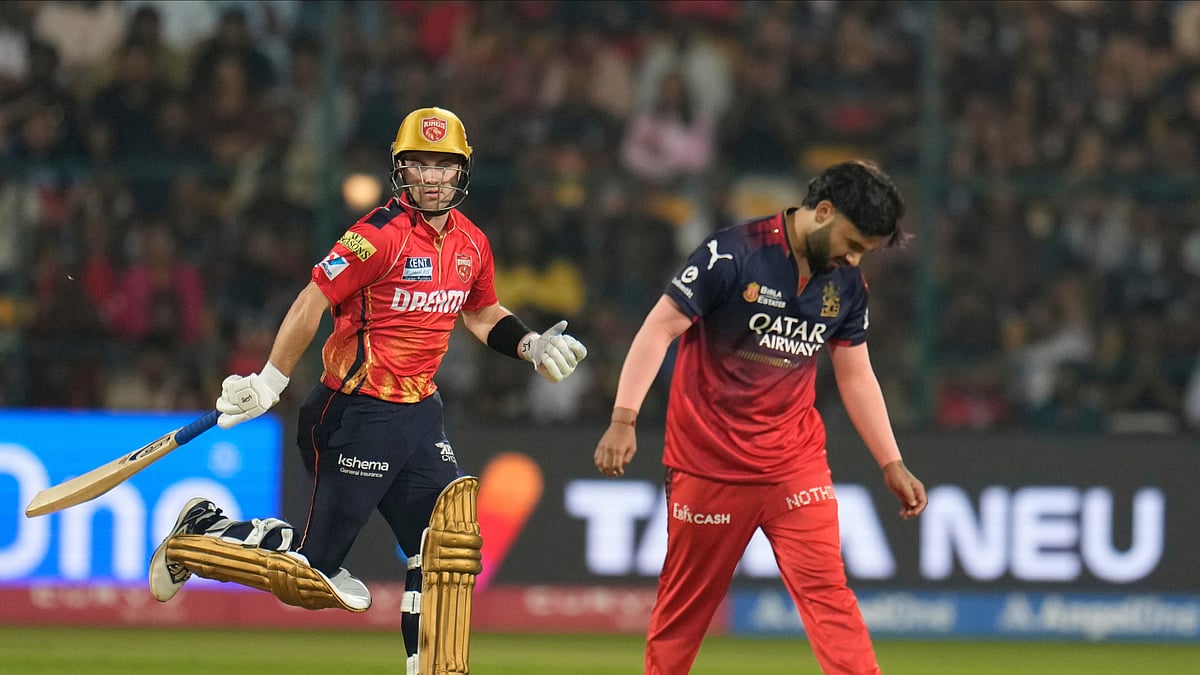 AP Photo/Aijaz Rahi : Punjab Kings' Josh Inglis takes a run as Royal Challengers Bengaluru's Suyash Sharma reacts during the Indian Premier League cricket match between Royal Challengers Bengaluru and Punjab Kings at Chinnaswamy Stadium in Bengaluru.