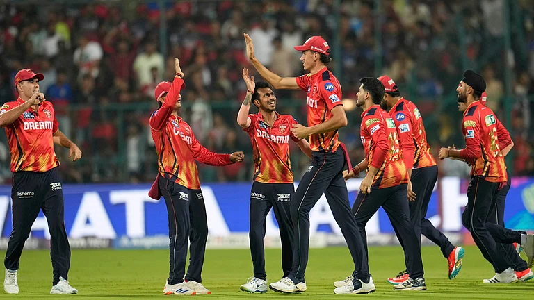 Punjab Kings players celebrates the dismissal of Royal Challengers Bengaluru's Virat Kohli during the Indian Premier League cricket match between Royal Challengers Bengaluru and Punjab Kings at Chinnaswamy Stadium in Bengaluru, India, Friday, April 18, 2025. - (AP Photo/Aijaz Rahi)
