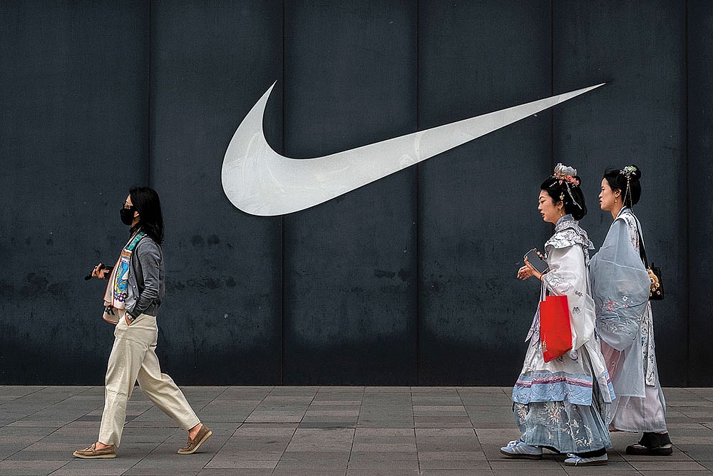 | Photo: Getty Images : Walking Away?: People pass by a Nike store in Beijing on April 8, 2025