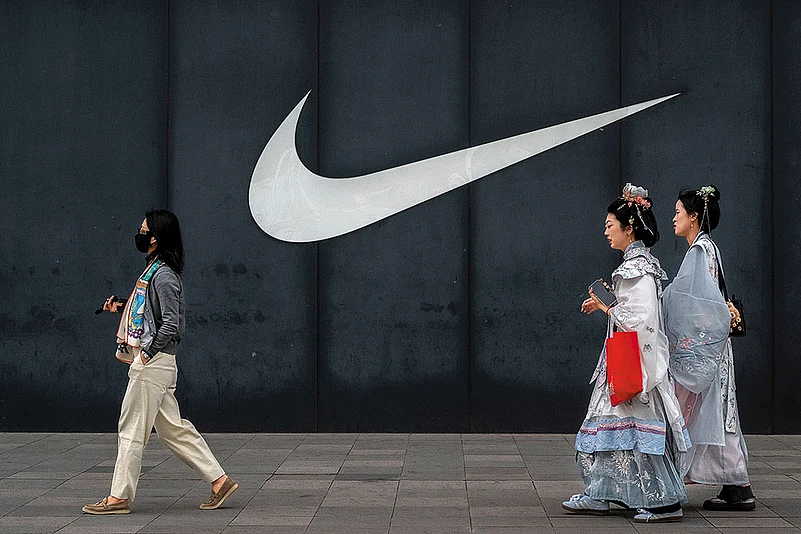 Walking Away? People pass by a Nike store in Beijing on April 8, 2025