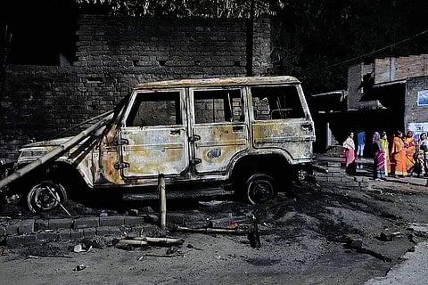 in Flames: A burnt vehicle in  Ranipul village in Dhulian