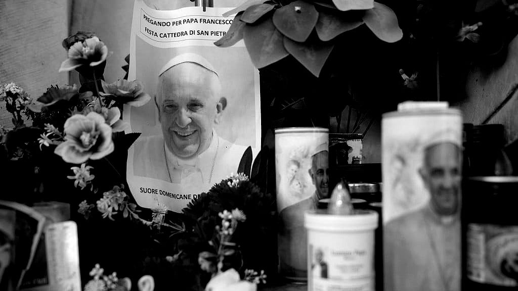 AP : Candles and a photo of Pope Francis are seen in front of the Agostino Gemelli Polyclinic, in Rome, Saturday, Feb. 22, 2025, where the Pontiff is hospitalized since Friday, Feb. 14.
