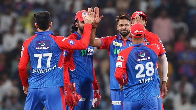 The Delhi Capitals celebrate one of Mukesh Kumar's four wickets - File