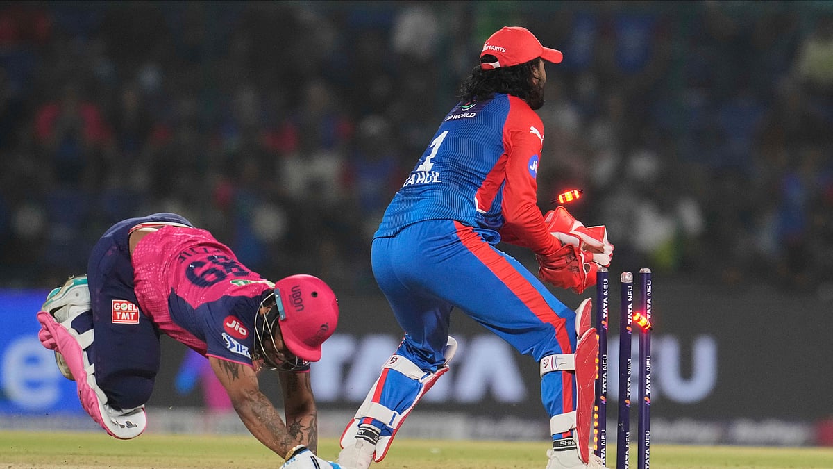 AP Photo/Manish Swarup : Delhi Capitals' wicketkeeper KL Rahul breaks the stumps as Rajasthan Royals' Shimron Hetmyer dives to make it successfully into the crease during the Indian Premier League cricket match between Delhi Capitals and Rajasthan Royals at Arun Jaitley Stadium in New Delhi.