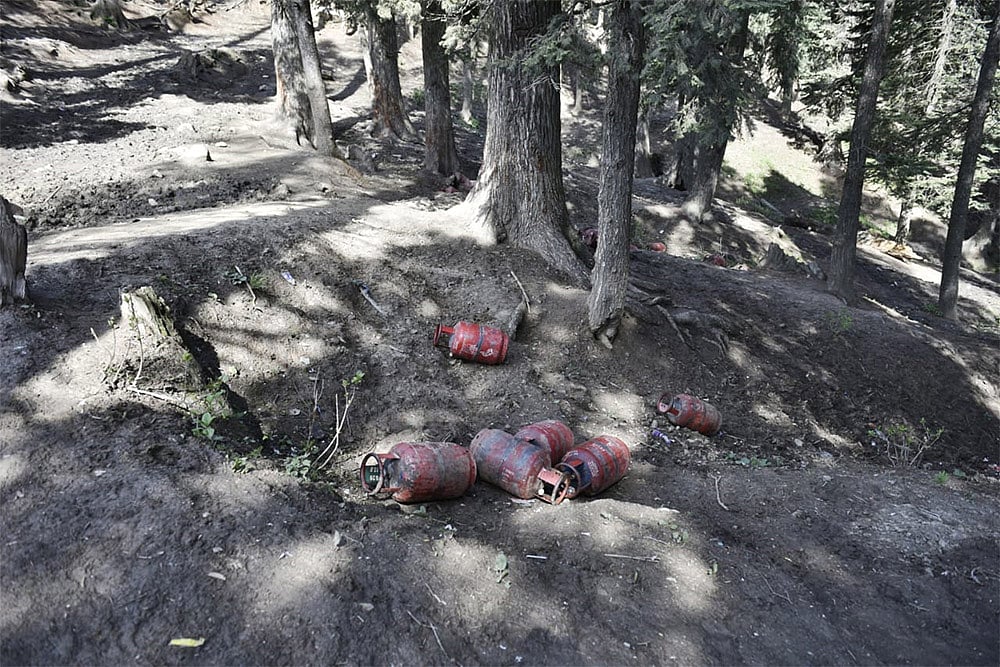 | Photo: Yasir Iqbal : Remnant of food stalls lie scattered in the forest near the tourist spot