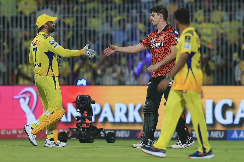 Mahendra Singh Dhoni, left, greets Pat Cummins