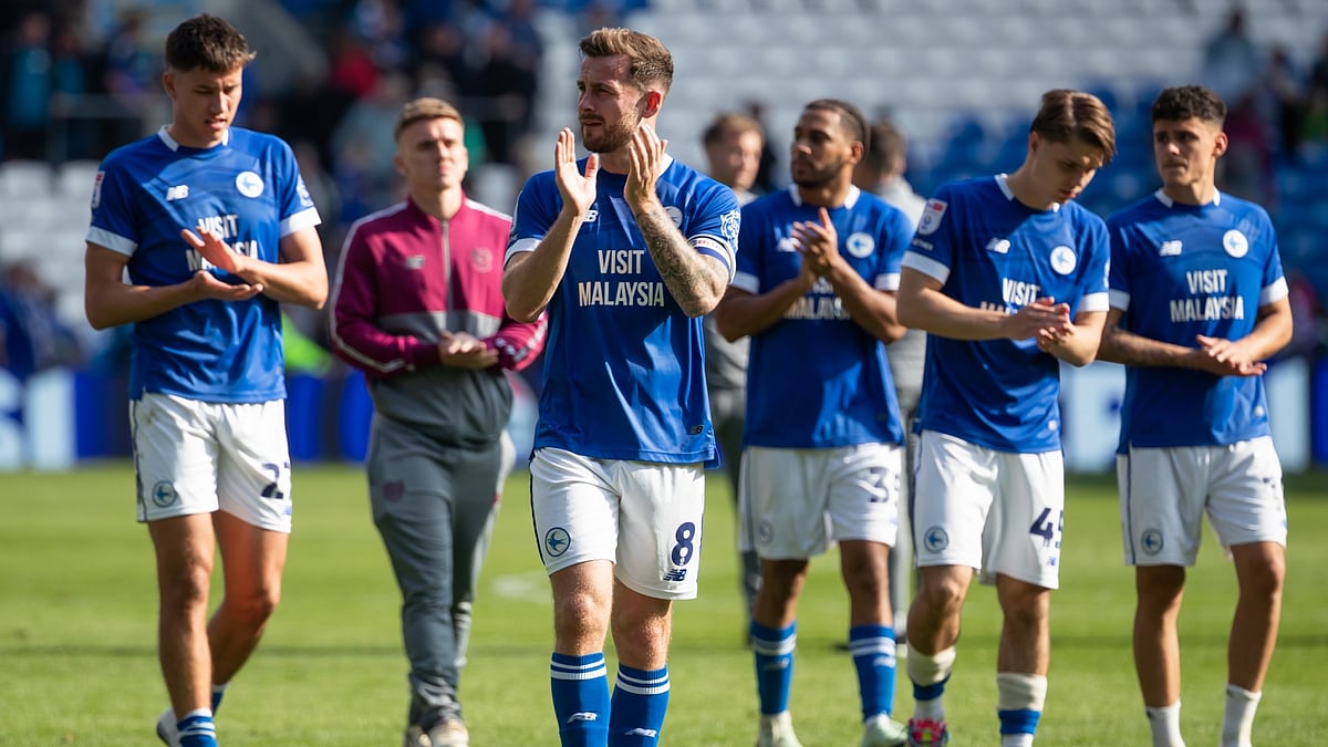 Cardiff City players applaud the fans.