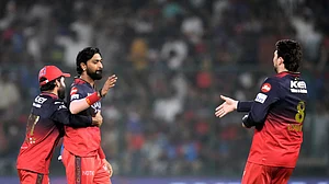AP Photo/Manish Swarup : Royal Challengers Bengaluru's Krunal Pandya, center, is hugged by captain Rajat Patidar for taking the wicket of Delhi Capitals' Faf du Plessis during the Indian Premier League cricket match in New Delhi.