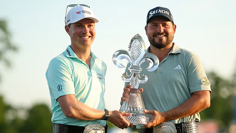 Ben Griffin and Andrew Novak pose with the Zurich Classic of New Orleans trophy. - null