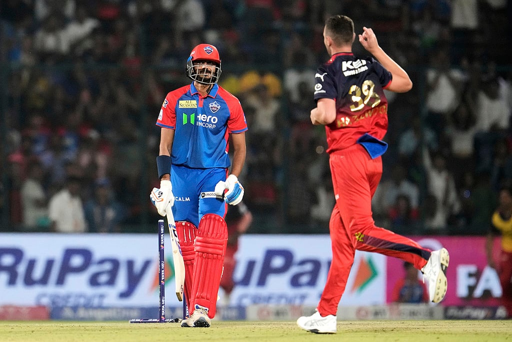 AP/Manish Swarup : Delhi Capitals' captain Axar Patel reacts after getting bowled out by Royal Challengers Bengaluru's Josh Hazlewood, right, during the Indian Premier League cricket match between Delhi Capitals and Royal Challengers Bengaluru at Arun Jaitley Stadium in New Delhi, India, Sunday, April 27, 2025.
