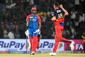 AP/Manish Swarup : Delhi Capitals' captain Axar Patel reacts after getting bowled out by Royal Challengers Bengaluru's Josh Hazlewood, right, during the Indian Premier League cricket match between Delhi Capitals and Royal Challengers Bengaluru at Arun Jaitley Stadium in New Delhi, India, Sunday, April 27, 2025.