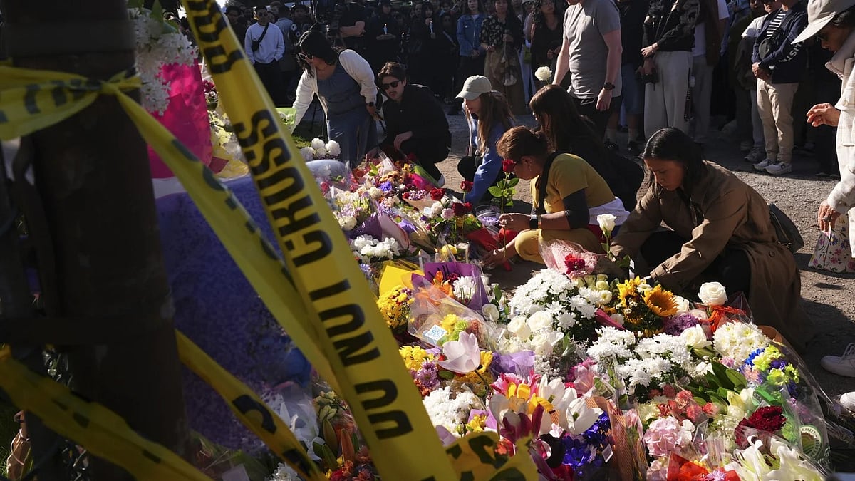| Pic- AP/ Lindsey Wasson : Visitors pay their respects at a memorial after a vehicle drove into a crowd during a Filipino heritage festival in Vancouver, British Columbia day, April 27, 2025.