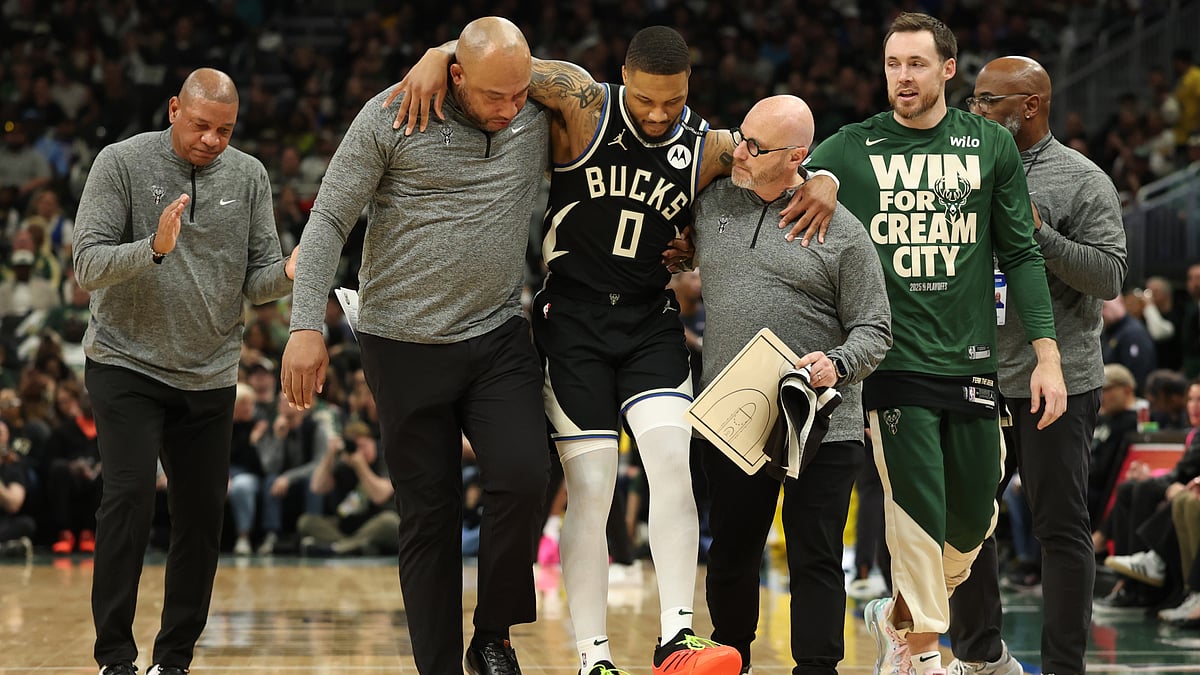 Damian Lillard was helped from the court midway through the first quarter.