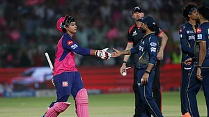 AP Photo/Surjeet Yadav : Gujarat Titans' Rahul Tewatia congratulates Rajasthan Royals' Vaibhav Suryavanshi, left, on playing a fine innings during the Indian Premier League cricket match in Jaipur.