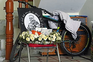 | Photo: Tribhuvan Tiwari : The Last Goodbye: A photograph of Lt Vinay Narwal, carried to his house by the Naval cadets, placed next to his favourite bike
