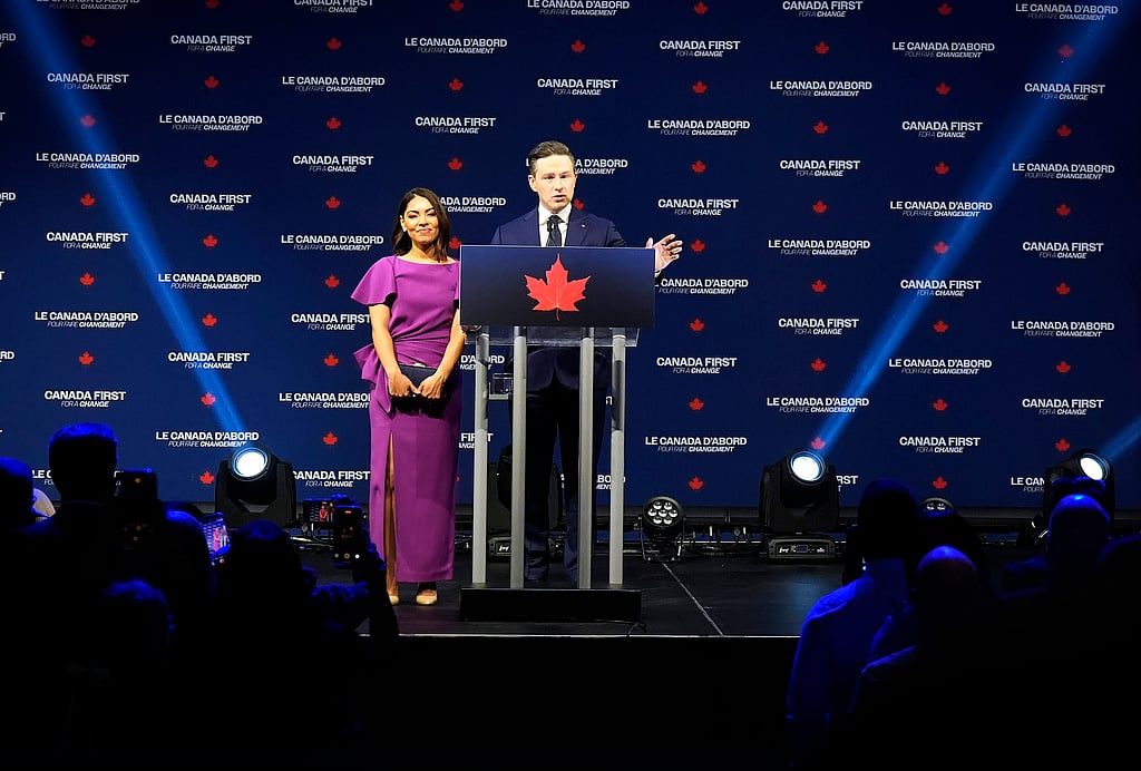 | Photo: Adrian Wyld for The Canadian Press/ AP : Conservative Leader Pierre Poilievre speaks to supporters with his wife Anaida Poilievre at his campaign headquarters on election night, in Ottawa