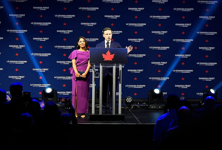Conservative Leader Pierre Poilievre speaks to supporters with his wife Anaida Poilievre at his campaign headquarters on election night, in Ottawa - | Photo: Adrian Wyld for The Canadian Press/ AP