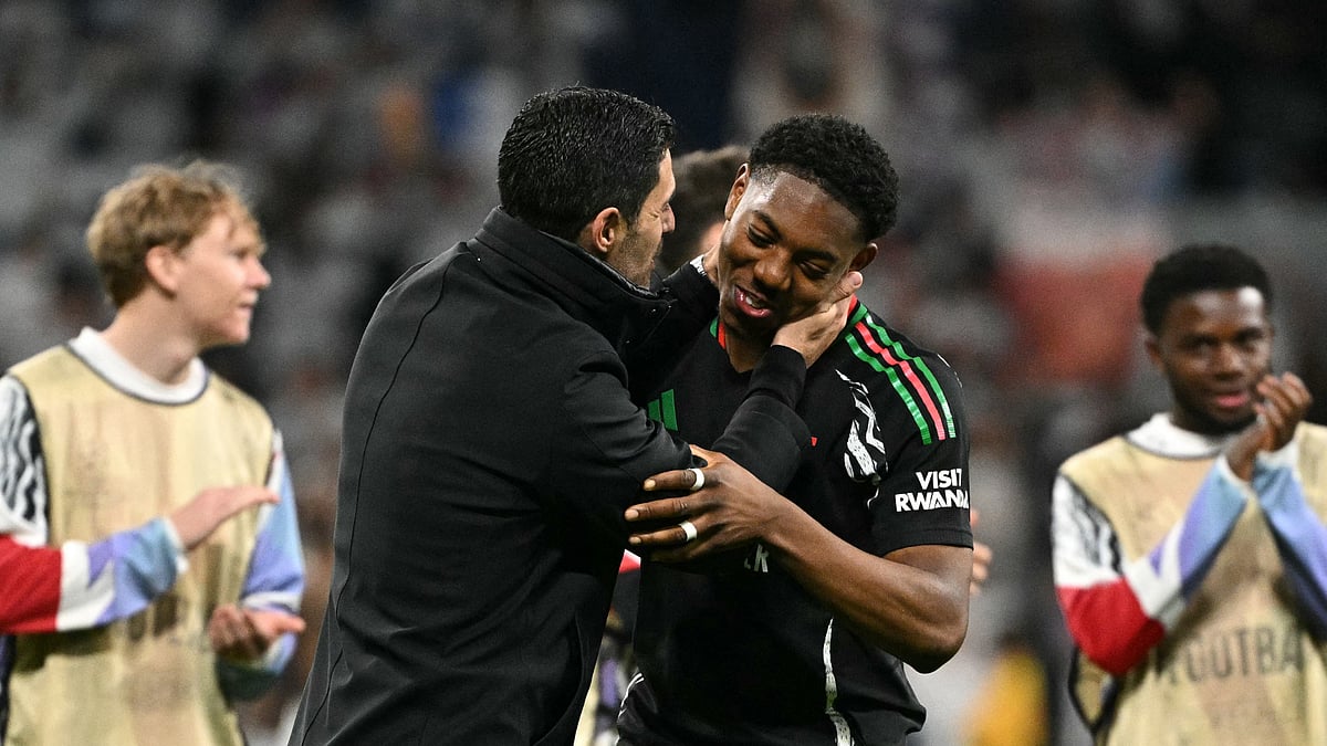 Myles Lewis-Skelly and Mikel Arteta embrace after Arsenal's win over Real Madrid - null