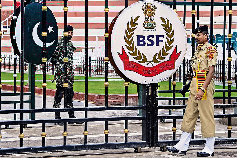 | Photo: PTI : Too Close for Comfort: Border Security Force soldiers and Pakistani Rangers stand guard at Attari-Wagah border