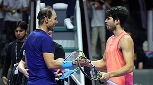 Rafael Nadal and Carlos Alcaraz share a handshake.