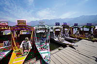 | Photo: AP : In Solidarity: Kashmiri boatmen hold placards to condemn the Pahalgam terror attack in Dal Lake, Srinagar