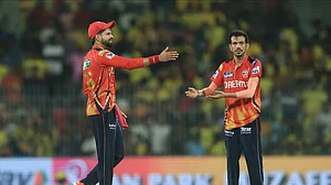 AP Photo/R. Parthibhan : Punjab Kings' Yuzvendra Chahal, right, celebrates the dismissal of Chennai Super Kings' Mahendra Singh Dhoni with team captain Shreyas Iyer at M. A. Chidambaram Stadium in Chennai.