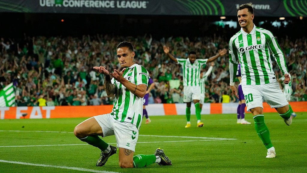 Photo: AP : Real Betis' Antony, left, reacts after scoring during the Conference League semi-final first leg match against Fiorentina at the Benito Villamarin stadium in Seville, Spain.