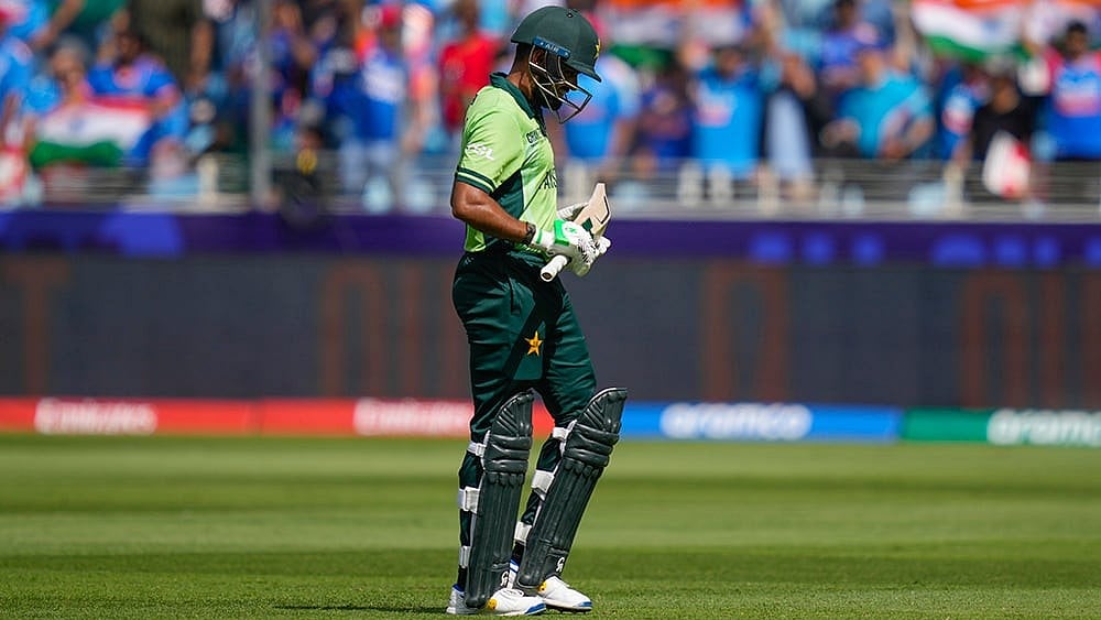 | Photo: AP/Altaf Qadri : ICC Champions Trophy, IND vs PAK: Pakistan's Babar Azam leaves the field after losing his wicket