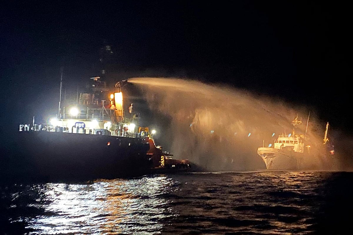 Malta Vessel Traffic Services via AP : A firefighting-equipped tug boat, left, contacted by the Malta Vessel Traffic Services (VTS) helps controlling a fire occurred on the bow of the Conscience vessel in international waters of the Mediterranean Sea, Friday, May 2, 2025. 