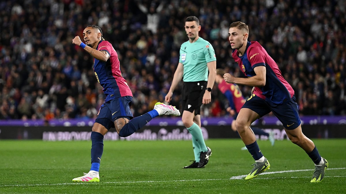 Raphinha and Fermin Lopez celebrate against Real Valladolid.