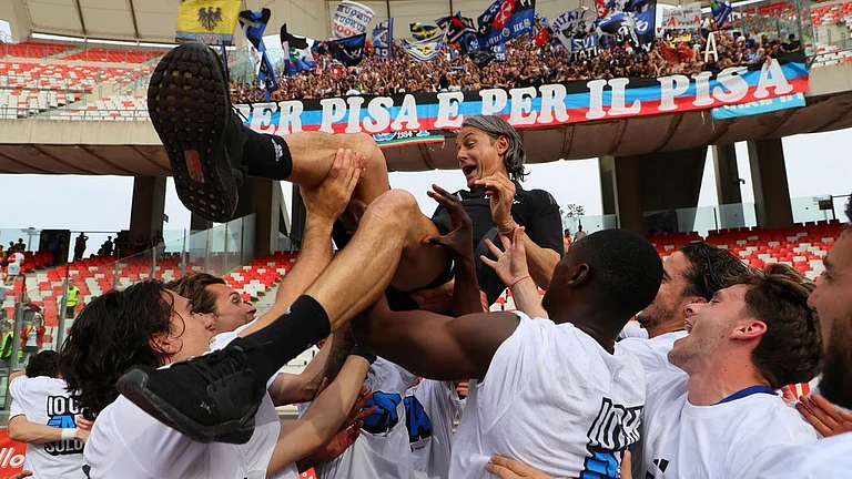 Players lift Pisa manager Filippo Inzaghi as they celebrate the promotion of soccer team Pisa to the Serie A league, after the match. - AP/Donato Fasano/LaPresse