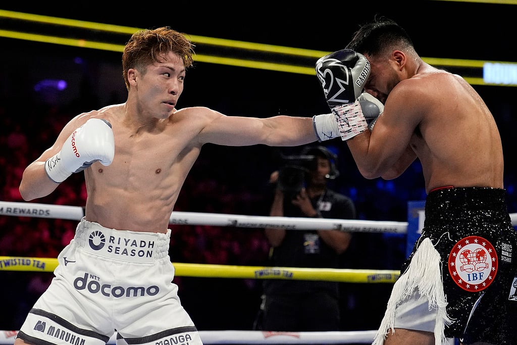 AP/John Locher : Naoya Inoue hits Ramon Cardenas in a junior featherweight title boxing match Sunday, May 4, 2025, in Las Vegas.