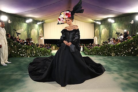 Zendaya in a floral headpiece and black vintage gown by John Galliano at Met Gala 2024