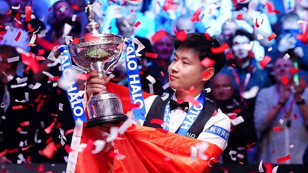 Mike Egerton/PA via AP : China's Zhao Xintong celebrates victory in the final match against Wales' Mark Williams following day seventeen of the World Snooker Championship at the Crucible Theatre, Sheffield, England, Monday, May 5, 2025.