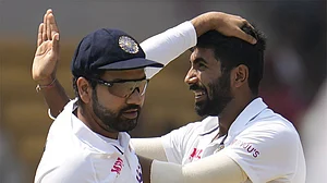 Photo: AP : India's former Test captain Rohit Sharma (L) with India's Test vice-captain Jasprit Bumrah.