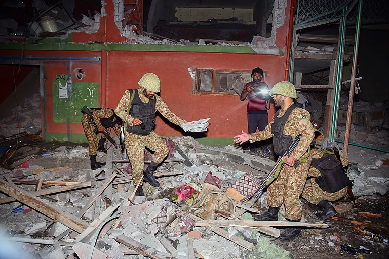 Army soldiers inspect a building damaged by a suspected Indian missile attack near Muzaffarabad, PoK - AP Photo/M.D. Mughal