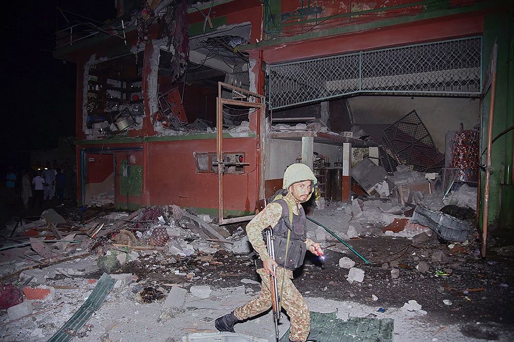 AP Photo/M.D. Mughal : Army soldiers inspect a building damaged by a suspected Indian missile attack near Muzaffarabad, the capital of Pakistan controlled Kashmir, Wednesday, May 7, 2025. 
