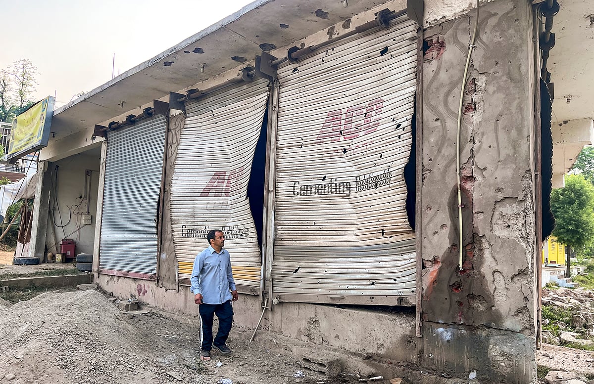 PTI : Poonch: A civilian looks at damaged properties after heavy firing and shelling by Pakistan military overnight across the Line of Control and International Border, at Mendhar area of Poonch district, Jammu and Kashmir, Wednesday, May 7, 2025. At least three civilians were killed and ten injured in the incident, according to officials. 