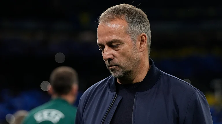 Barcelona coach Hansi Flick looks dejected after their loss to Inter. - null