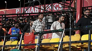 AP Photo/Ashwini Bhatia : Spectators leave the stands after authorities evacuated the stadium during the Indian Premier League cricket match in Dharamshala.