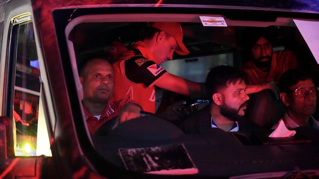 Photo: AP : Punjab Kings' Marco Jansen is seen wearing a cap in the bus as he leaves with team members after the authorities asked to evacuate the stadium during the Indian Premier League match against Delhi Capitals.