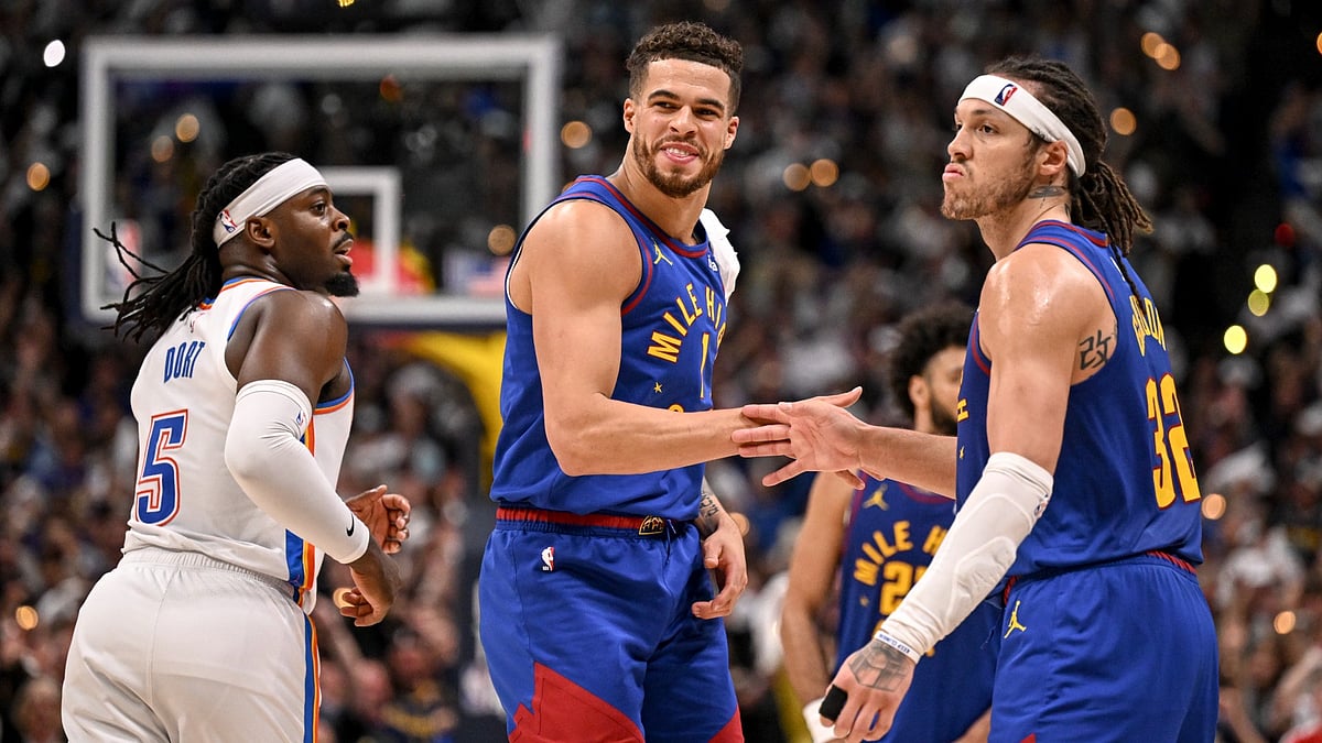 Michael Porter Jr. (1) of the Denver Nuggets smiles as he shakes hands with Aaron Gordon (32) after a mid-range jumper by Gordon during overtime of the Nuggets' 113-104 win over the Oklahoma City Thunder at Ball Arena in Denver, Colorado on Friday, May 9, 2025. The Nuggets took a 2-1 series lead in their Western Conference semifinal.