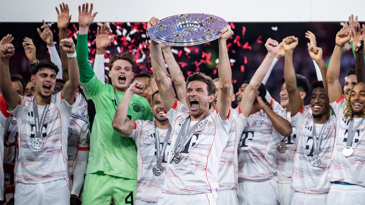 Thomas Muller lifts the Bundesliga trophy