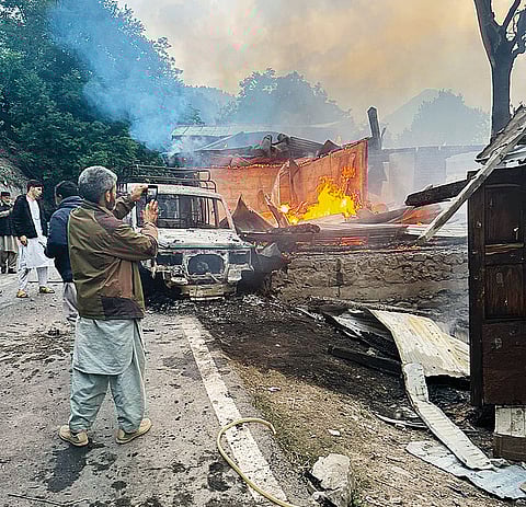 A house on fire at Hajinar as a result of shelling along the Line of Control (LoC)