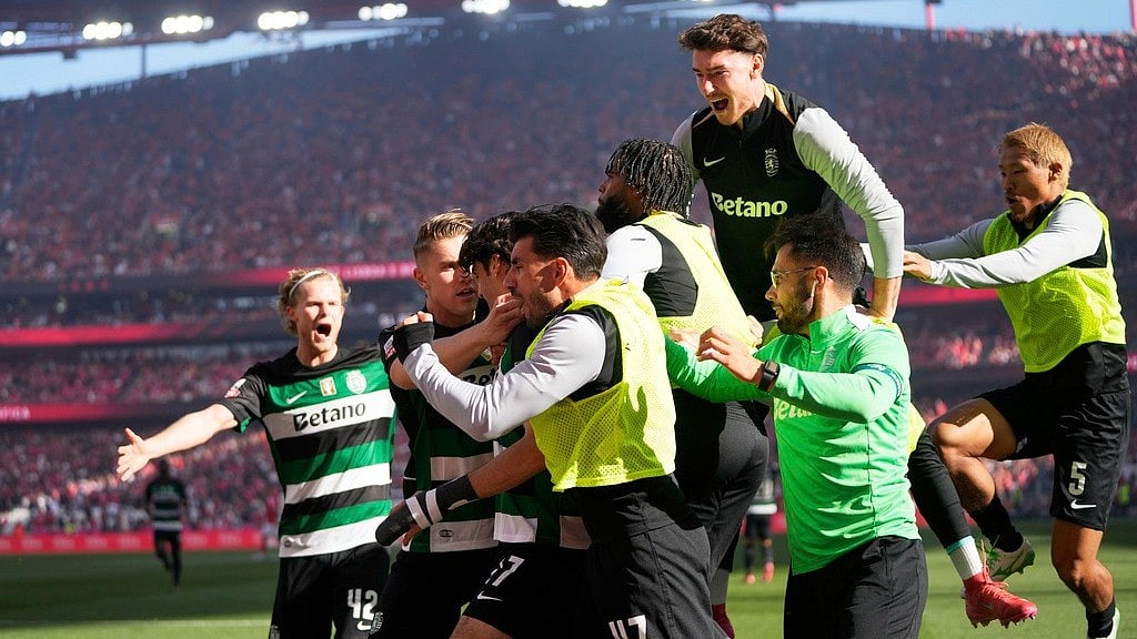 | Photo: AP/Armando Franca : Sporting CP's Francisco Trincao is congratulated after scoring his side's opening goal during the Portuguese Primeira Liga match against SL Benfica.