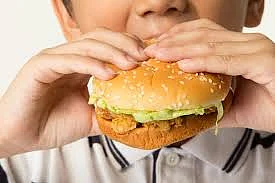 A kid eating a burger